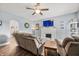 A comfortable living room features a fireplace and TV, oversized couch, hardwood floors, and light-gray walls at 379 N Marion St, Morgantown, IN 46160