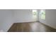 Bright bedroom with sleek wood floors and two windows overlooking the outdoor landscape at 3917 Highcrest Rd, Indianapolis, IN 46239