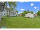 A spacious backyard, partially fenced, features a large garage and well maintained lawn at 422 W Broadway St, Greenwood, IN 46142
