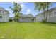 Well-maintained backyard with lush green grass and an updated detached garage; perfect for outdoor activities at 422 W Broadway St, Greenwood, IN 46142