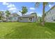 Wide backyard view of a well-manicured lawn and a gray home with sliding glass door at 422 W Broadway St, Greenwood, IN 46142