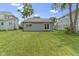 Spacious backyard featuring a well-maintained lawn and a gray home with a sliding glass door at 422 W Broadway St, Greenwood, IN 46142