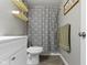 Renovated bathroom with new vanity, decorative shelves, striped shower curtain, and modern fixtures at 422 W Broadway St, Greenwood, IN 46142