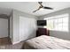 Comfortable bedroom with natural light from a large window, a ceiling fan, and closet space at 422 W Broadway St, Greenwood, IN 46142
