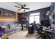 Bedroom featuring bright blue walls, a couch, window, desk and ceiling fan with an attached light at 422 W Broadway St, Greenwood, IN 46142