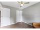 Clean bedroom featuring a soft chair, closet, ceiling fan and a window with white blinds at 422 W Broadway St, Greenwood, IN 46142