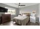 A well-lit bedroom featuring a ceiling fan, a large window, and neutral-toned furnishings at 422 W Broadway St, Greenwood, IN 46142