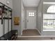 Neutral entryway with hardwood floors, coat rack, and a view of the front door at 422 W Broadway St, Greenwood, IN 46142
