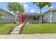 Charming gray home with a red front door and cozy front porch at 422 W Broadway St, Greenwood, IN 46142