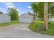 View of a two car detached garage with a concrete driveway and grassy lawn at 422 W Broadway St, Greenwood, IN 46142