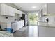 The kitchen features white cabinetry and stainless steel appliances, with access to the backyard at 422 W Broadway St, Greenwood, IN 46142