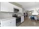 Open kitchen flows into the living area and features modern stainless steel appliances and sleek white cabinetry at 422 W Broadway St, Greenwood, IN 46142