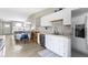 Open-concept kitchen featuring white cabinets, stainless steel appliances, and seamless flow to the living area at 422 W Broadway St, Greenwood, IN 46142