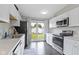Kitchen features stainless steel appliances, white cabinets, and a view of the backyard at 422 W Broadway St, Greenwood, IN 46142
