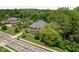 Birds-eye view of a brick home on a well-manicured lot surrounded by lush, mature trees at 4529 Panthera Leo Dr, Carmel, IN 46074