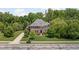 Beautiful aerial view of brick home with professionally landscaped lawn and mature trees at 4529 Panthera Leo Dr, Carmel, IN 46074