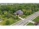 Aerial view of house with long driveway, well-manicured lawn and mature trees at 4529 Panthera Leo Dr, Carmel, IN 46074