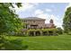Expansive backyard with lush greenery and deck, perfect for outdoor living at 4529 Panthera Leo Dr, Carmel, IN 46074