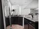 Finished basement area with a granite-topped bar, dark wood cabinetry, and a beverage refrigerator at 4529 Panthera Leo Dr, Carmel, IN 46074