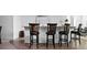 View of four bar stools with wood and copper seat backs at a kitchen bar at 4529 Panthera Leo Dr, Carmel, IN 46074