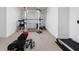 Basement area with home gym equipment, including weight rack, bench, and treadmill on carpeted floor at 4529 Panthera Leo Dr, Carmel, IN 46074