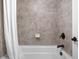 Bathroom featuring a white tub with decorative tile surround, soap dish, and black faucet at 4529 Panthera Leo Dr, Carmel, IN 46074