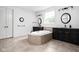 Elegant bathroom features a soaking tub with custom tile surround, dual vanities, and natural light at 4529 Panthera Leo Dr, Carmel, IN 46074