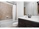 Bathroom with a shower and tub combo, neutral tile, and a vanity with a dark cabinet at 4529 Panthera Leo Dr, Carmel, IN 46074