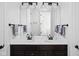 Bathroom with dual sinks, granite countertop, and dark cabinets at 4529 Panthera Leo Dr, Carmel, IN 46074