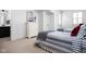 Bright bedroom with twin beds, a white dresser, and neutral decor at 4529 Panthera Leo Dr, Carmel, IN 46074