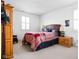 Comfortable bedroom with a stylish bed, windows with blinds, and a side table with lamps at 4529 Panthera Leo Dr, Carmel, IN 46074