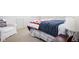 Cozy bedroom showcasing a comfortable bed with a patterned quilt and a chair with a 'Home Sweet Home' pillow at 4529 Panthera Leo Dr, Carmel, IN 46074