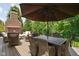 Spacious deck with fireplace, a large umbrella, and outdoor dining set at 4529 Panthera Leo Dr, Carmel, IN 46074