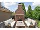Inviting outdoor deck featuring a charming brick fireplace and comfortable seating at 4529 Panthera Leo Dr, Carmel, IN 46074