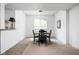 Dining room features a wooden table with four chairs in front of a window, exuding simple elegance at 4529 Panthera Leo Dr, Carmel, IN 46074