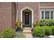 Charming front door with a decorative wreath, surrounded by well-maintained landscaping at 4529 Panthera Leo Dr, Carmel, IN 46074
