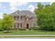Beautiful two-story brick home with manicured lawn and professional landscaping at 4529 Panthera Leo Dr, Carmel, IN 46074