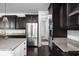 Eat-in kitchen featuring dark wood cabinetry, granite countertops and stainless steel appliances at 4529 Panthera Leo Dr, Carmel, IN 46074