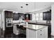 Updated kitchen with dark cabinets, granite countertops, stainless appliances, an island and pendant lighting at 4529 Panthera Leo Dr, Carmel, IN 46074