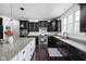 Spacious kitchen featuring dark cabinetry, granite countertops, a large island and stainless steel appliances at 4529 Panthera Leo Dr, Carmel, IN 46074