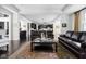 Open-concept living room with hardwood floors, a fireplace, and seamless access to the kitchen at 4529 Panthera Leo Dr, Carmel, IN 46074