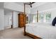 Bright main bedroom with four-poster bed, neutral carpeting and multiple windows offering ample natural light at 4529 Panthera Leo Dr, Carmel, IN 46074