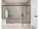 Modern walk-in shower with glass enclosure, tiled walls, bench, and updated fixtures at 4529 Panthera Leo Dr, Carmel, IN 46074