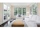 Bright sunroom features lots of windows, a couch, and a door leading to the back porch at 4529 Panthera Leo Dr, Carmel, IN 46074