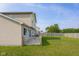 Well-maintained backyard featuring a spacious green lawn, a fenced perimeter, and mature trees at 4605 Clairmont Dr, Columbus, IN 47203