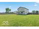 Expansive backyard with lush green grass, a privacy fence, and ample space for outdoor activities at 4605 Clairmont Dr, Columbus, IN 47203