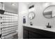 Well-lit bathroom featuring a double sink vanity and a shower tub combination at 4605 Clairmont Dr, Columbus, IN 47203
