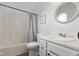 Functional bathroom with a combined shower tub and a vanity featuring a framed round mirror at 4605 Clairmont Dr, Columbus, IN 47203