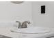 A close-up of a bathroom sink with a stainless steel faucet and white countertop at 4605 Clairmont Dr, Columbus, IN 47203
