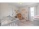Cozy Bedroom with crib, armchair, and natural light from the window at 4605 Clairmont Dr, Columbus, IN 47203